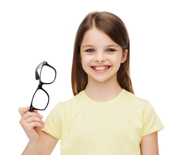 smiling cute little girl holding black eyeglasses - Foto, Imagem