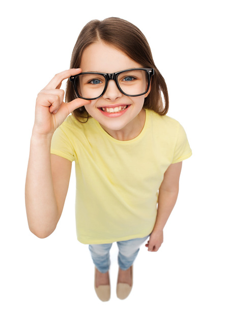 smiling cute little girl in black eyeglasses - Foto, Imagem