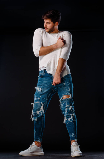 Studio body shot van een mode mannelijk model dragen stijlvolle kleding - Foto, afbeelding