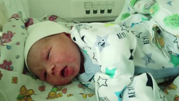 Newborn baby in maternity hospital. The baby was just born and he was changed into clean clothes. - Footage, Video