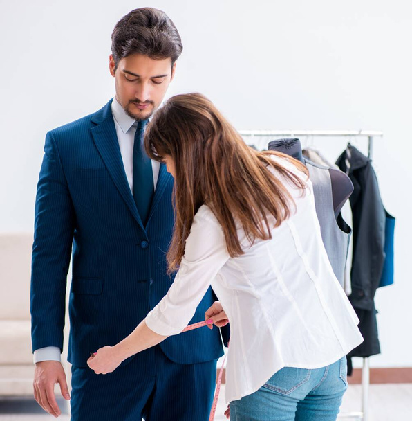 Professional tailor taking measurements for formal suit - Photo, Image