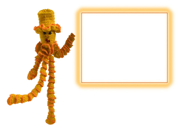 Knitted doll in an orange hat with a form - Photo, Image
