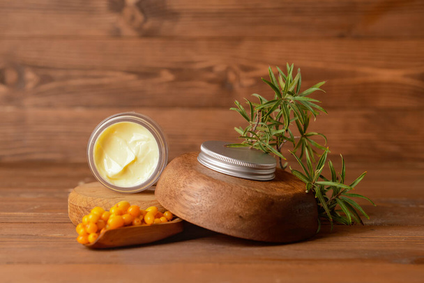 Jar of healthy sea buckthorn cream on wooden background - Photo, Image
