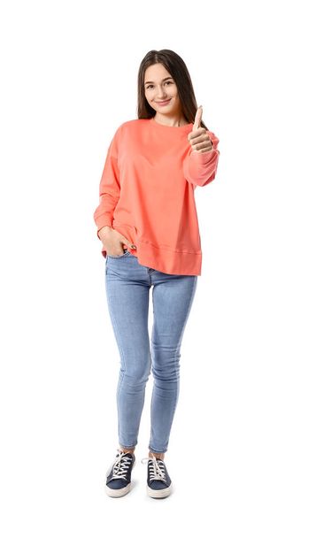 mooie jonge vrouw tonen thumb-up op witte achtergrond - Foto, afbeelding