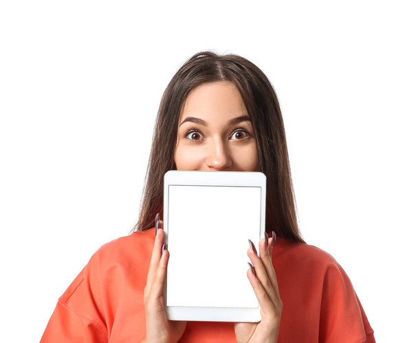 Surprised young woman with tablet computer on white background - Photo, Image
