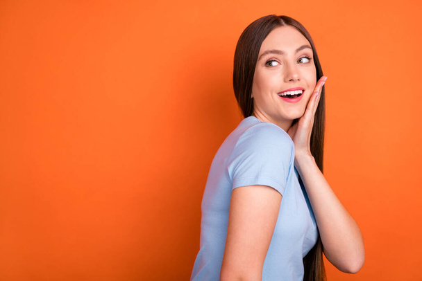 Profile photo of hooray long hairdo young lady hand face look empty space wear blue t-shirt isolated on vivid orange color background - Fotó, kép