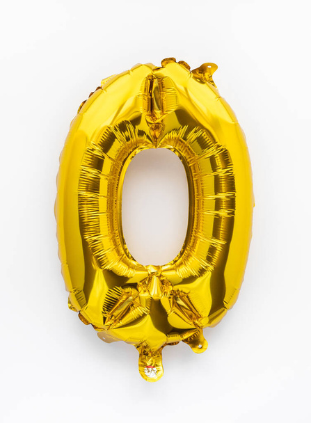 Number 0 golden foil balloon party decor on white background, baby birthday concept - Fotografie, Obrázek