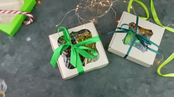 Gift boxes with dried fruits nuts individually wrapped set in female hands. Healthy food diet. Christmas celebration holidays preparing, organic eco natural mix. Conscious consumption homemade sweets. - Footage, Video