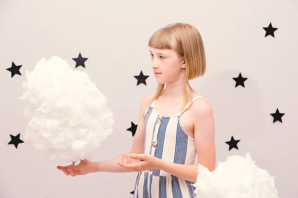 Teenage girl in the clouds: conceptual metaphorical image - Zdjęcie, obraz