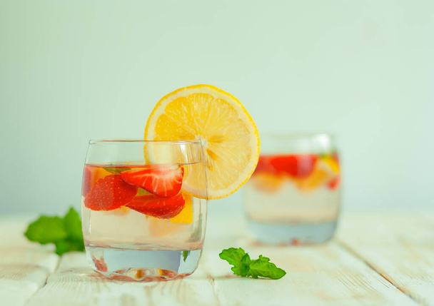 strawberry citrus summer refreshing beverage. lemon water with berries. strawberry, lemon and mint cocktail with soda - 写真・画像