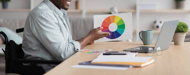 Hombre creativo en el lugar de trabajo. Diseñador trabajando con la paleta de colores en el escritorio de la oficina, eligiendo muestras de color para el proyecto - Foto, imagen