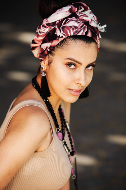 Portrait of a beautiful Indian girl in scarf. Young hippie style woman wearing handmade jewelry - Fotoğraf, Görsel