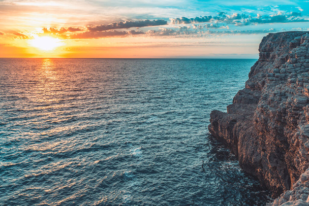 Amazing colorful sky sunrise above mountains cliffs and deep blue ocean - Φωτογραφία, εικόνα