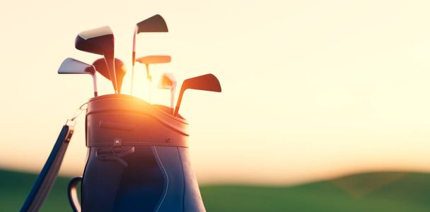 Golf clubs in bag at golf course resort at sunset - Photo, Image