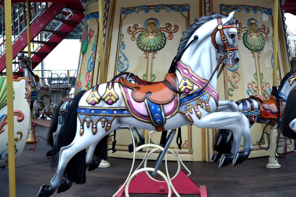 Vintage european carousel in a park. Merry go round horses. Retro style carousel. - Foto, imagen