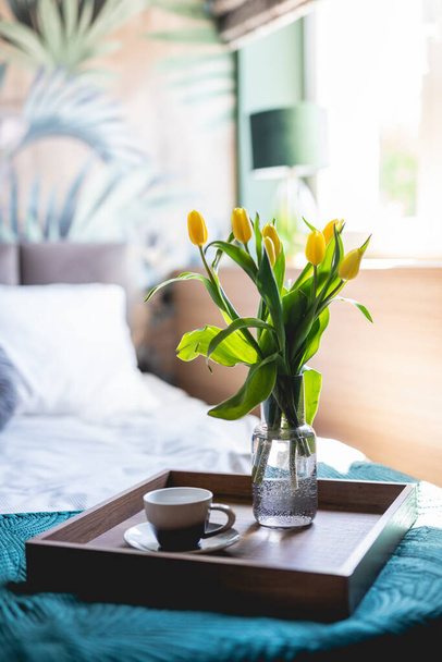 Coffee and flowers on bed tray in elegant bedroom. Home staging - Fotografie, Obrázek