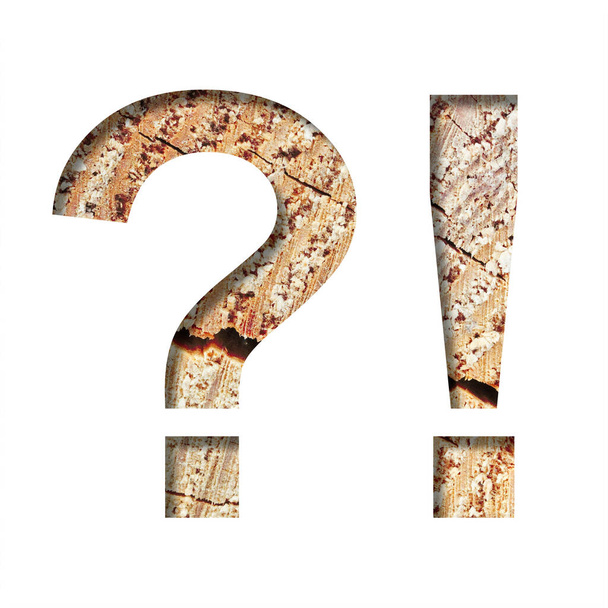 Wood cut font. Exclamation and question marks cut out of paper on the background of a cut of a tree with cracks and shavings. Set of decorative natural fonts. - Foto, Imagem
