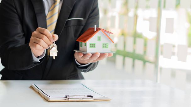 Agence immobilière offre un contrat pour acheter une maison pour acheter une maison ou un appartement ou discuter d'un prêt et les taux d'intérêt, l'achat d'une maison et de louer des idées. - Photo, image