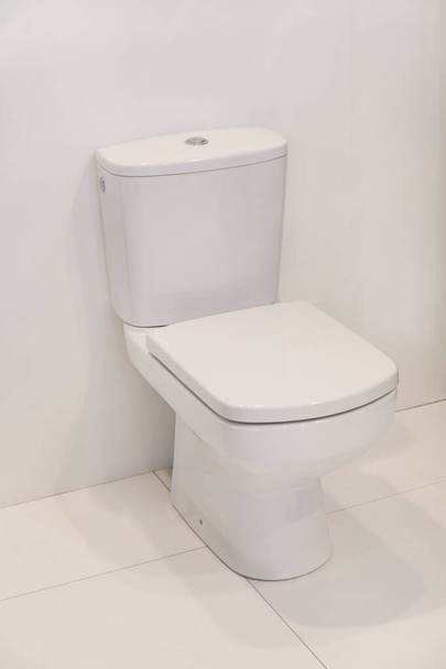 Closed Seat at Toilet Block in Clean White Bathroom - Zdjęcie, obraz