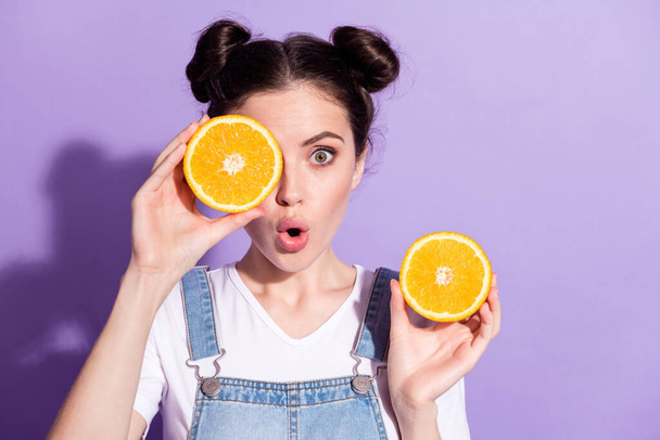 Photo of cute impressed young lady wear jeans overall orange half piece close eye isolated violet color background - Foto, Imagen