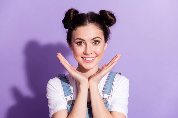 Photo of young attractive girl happy positive toothy smile bun isolated over violet color background - Foto, Imagen