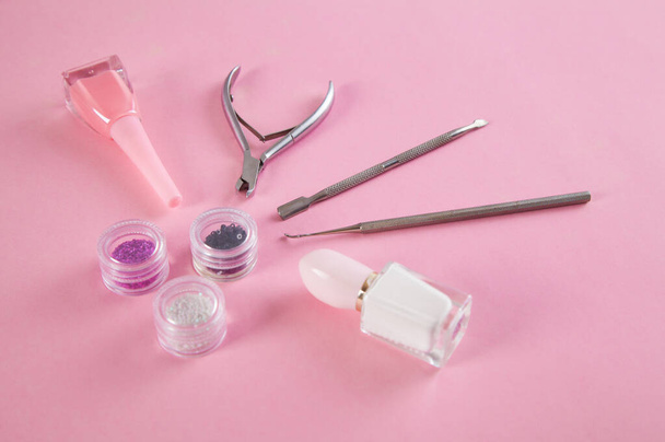 Manicure accessories on an isolated pink background. - Foto, imagen
