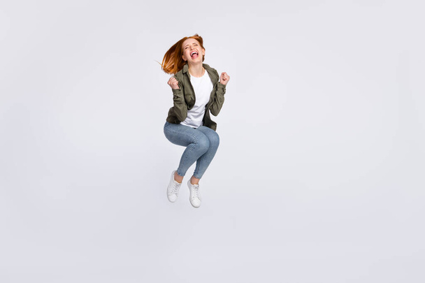 Full length photo of funny cute red hair lady jump wear grey shirt isolated on white color background - Photo, image