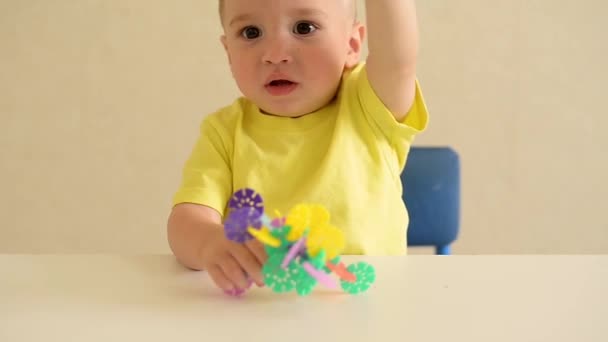 toddler boy plays draws on a piece of paper with a red pen sitting at a white table. educational game Montessori fine motor skills. early development concept - Footage, Video