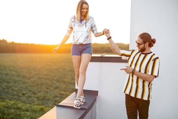 Couple walk on the rooftop at sunset - Foto, immagini