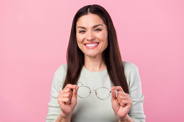Photo of charming happy nice young woman hold hands glasses cute smile isolated on pink color background - Φωτογραφία, εικόνα