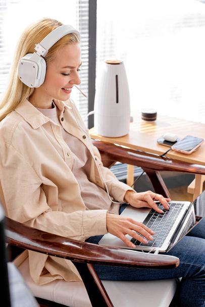working at home, smart working. female uses laptop and modern devices, smile - Фото, зображення