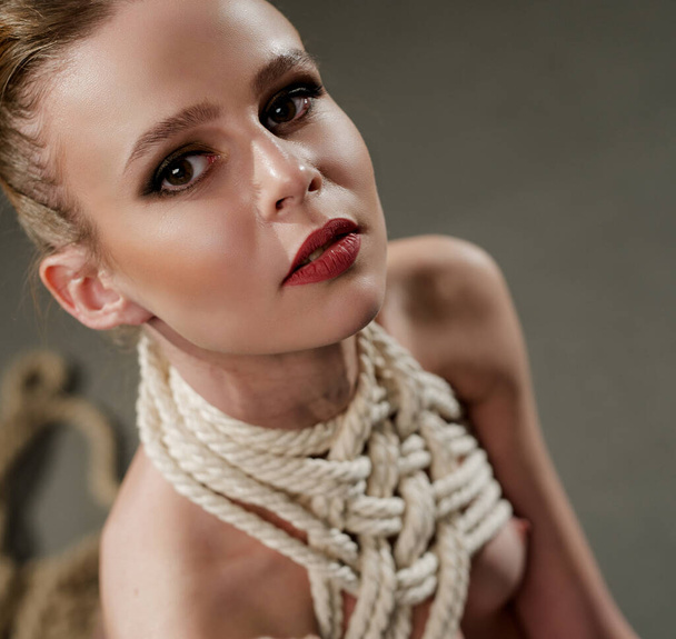 Woman tied up with rope high angle portrait - Foto, Bild