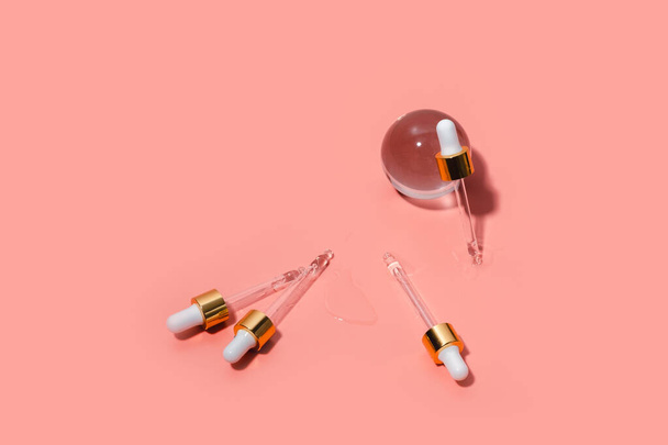 Dropper glass bottles with pipette. Transparent hyaluronic natural beauty product and eco serum skin care concept. Top horizontal view copyspace. - 写真・画像