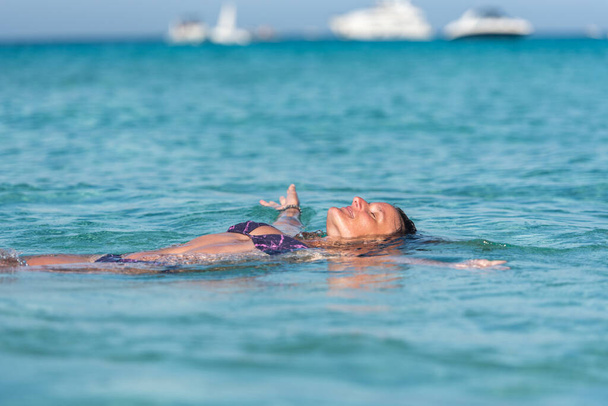 Young man on Levante beach in Formentera, Spain in summer 2021. - Photo, Image