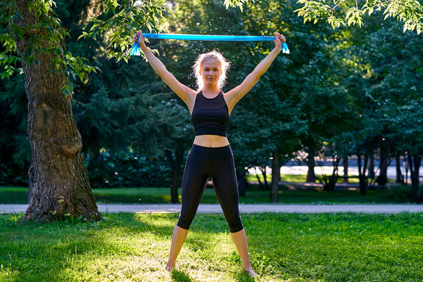 Yoga. Young woman practicing yoga or dancing or stretching in nature at park. Health lifestyle concept. - Φωτογραφία, εικόνα