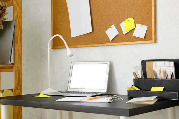 Modern workplace with laptop near light wall - Foto, immagini