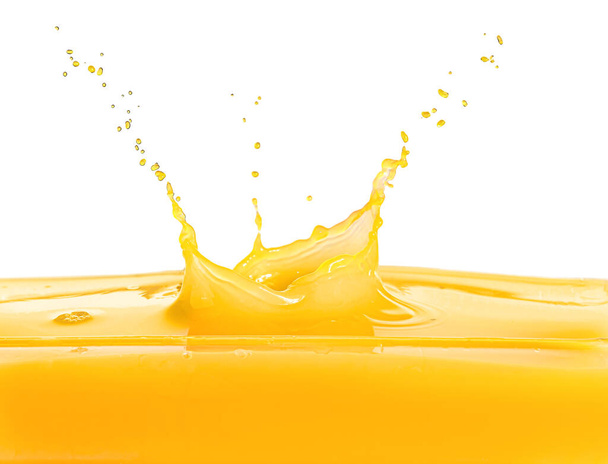 Splash of fresh orange juice on white background - Photo, Image