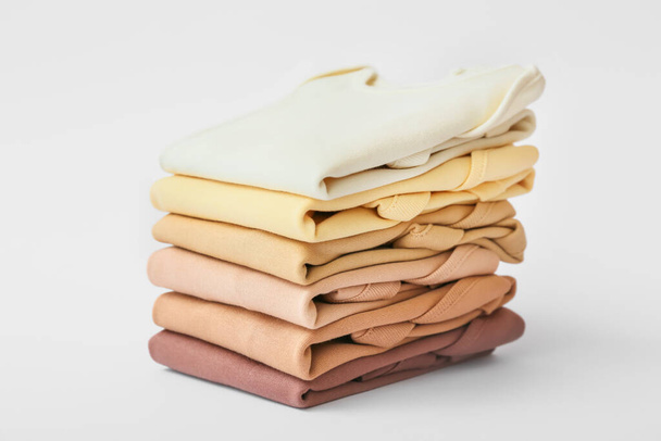 Stack of baby clothes on light background - Photo, Image