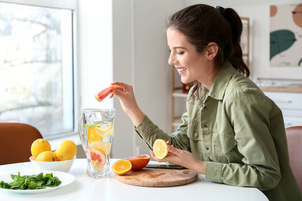 Jovem mulher fazendo limonada fresca em casa - Foto, Imagem