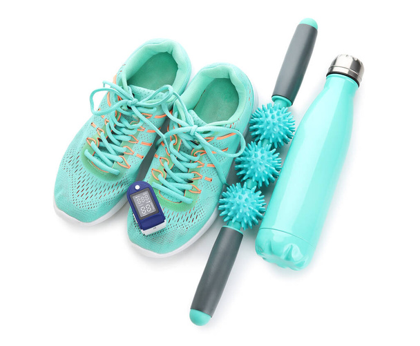 Set of sports items and pulse oximeter on white background - Photo, Image