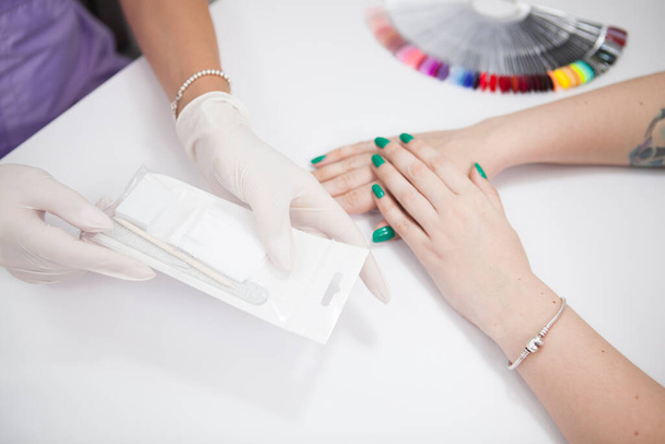 Top view cropped shot of manicurist using individual manicure instruments set with new client - Фото, изображение