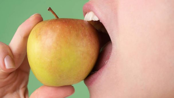 Dental Care. Healthy white teeth close up with an apple. - Zdjęcie, obraz