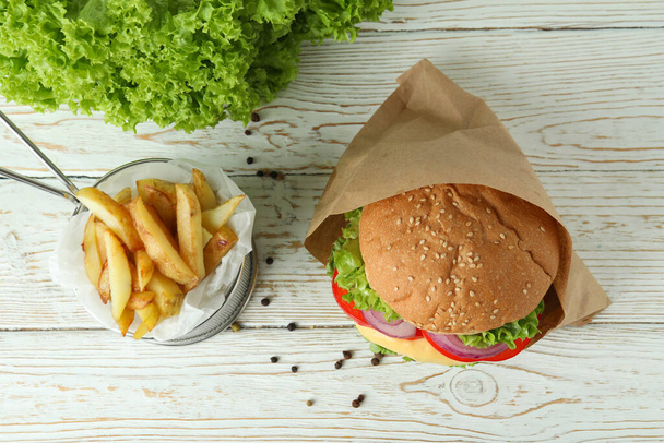 Concept of tasty food with delicious burger - Фото, изображение
