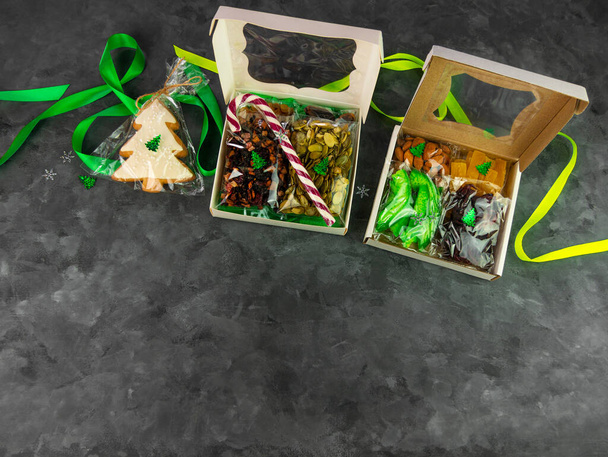 Gift box with set of different dried fruits nuts citrus individually wrapped flat lay. Healthy food diet. Christmas celebration, organic eco natural mix top view. Conscious consumption mindful eating. - Photo, Image