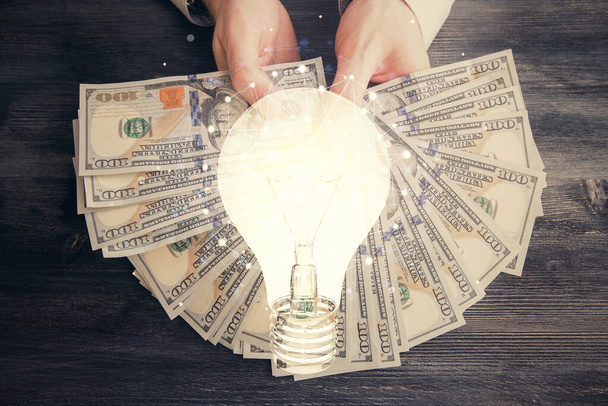 Multi exposure of bulb drawing hologram and USA dollars bills and man hands. Business Idea concept. - Foto, Imagen