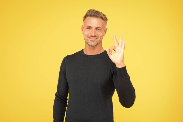 handsome man wear black and show ok gesture. male fashion and beauty. guy looking stylish and trendy. barbershop concept. care his bristle and hair. confident guy - Valokuva, kuva