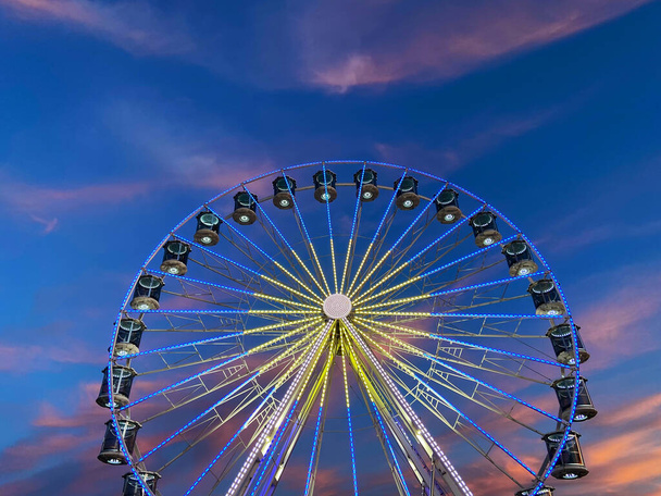 High Ferris Wheel on a sunset backdrop in our summer vacation. Amusement park ride. Adriatic coast in Slovenia.  - Photo, Image