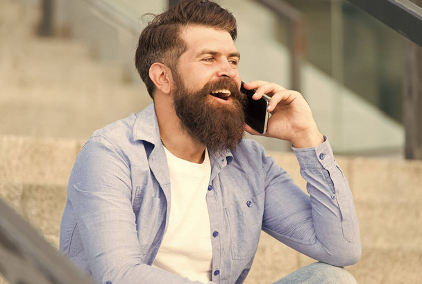 Glad to hear you again. Mobile communication. Mobile conversation. Man with smartphone urban background. Handsome man with phone outdoors. Modern life. Calling friend. Talking concept. Informing - Foto, Bild