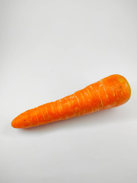 Photo of fresh carrots isolated on white background in mini studio - Photo, Image