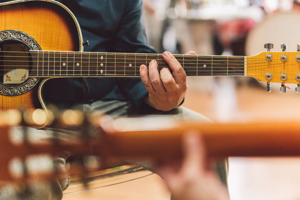 Hands of a man playing the guitar in duet - Φωτογραφία, εικόνα